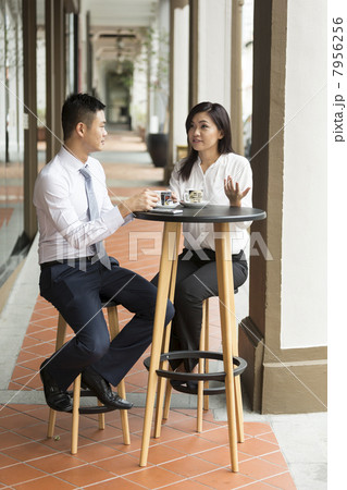 Two Asian business colleagues at a cafe Two Asian business colleagues at a cafe 7956256