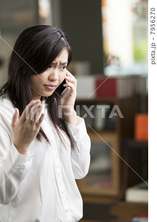 Angry Chinese Business woman talking on phone 7956270
