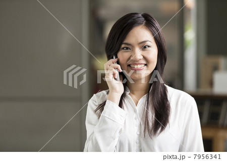 Close up portrait of a Chinese Business woman talking on phone Close up portrait of a Chinese Business woman talking on phone 7956341