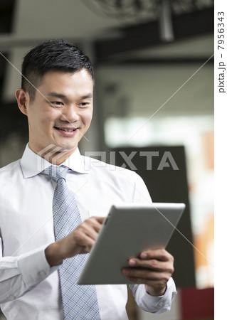 Chinese man with a tablet computer. Chinese man with a tablet computer. 7956343