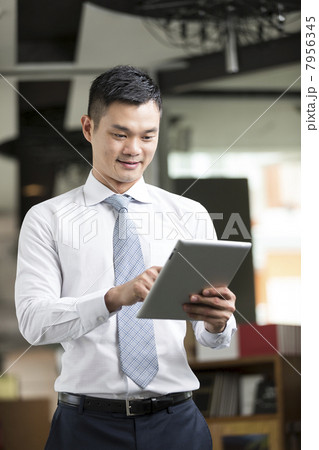 Chinese man with a tablet computer. Chinese man with a tablet computer. 7956345