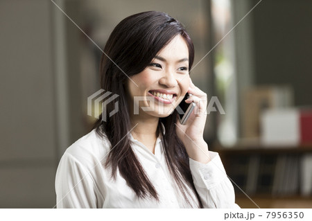 Close up portrait of a Chinese Business woman talking on phone Close up portrait of a Chinese Business woman talking on phone 7956350