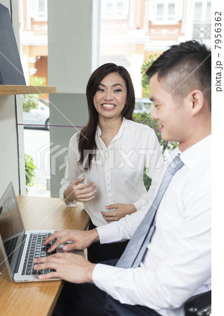 Chinese business colleagues using a laptop computer. Chinese business colleagues using a laptop computer. 7956362