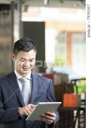 Chinese man with a tablet computer. Chinese man with a tablet computer. 7956367