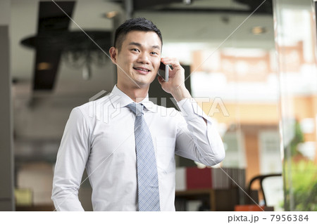 Chinese Business man talking on phone 7956384