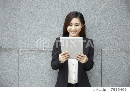 Chinese business woman with a tablet computer. Chinese business woman with a tablet computer. 7956461