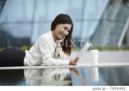 Asian Business woman using a digital tablet outside 7956462