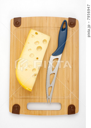 Cheese and knife on a wooden board 7956947