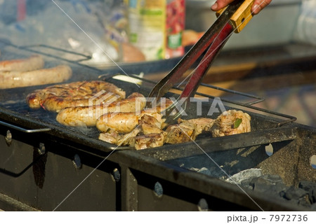 Sausages and meat on the grill 7972736