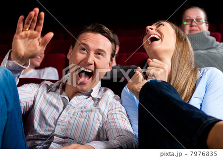 Couple and other people in cinema 7976835