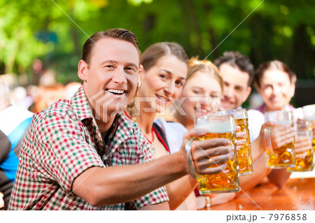 In Beer garden - friends drinking beer 7976858