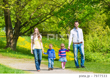 Happy family having walk in summer meadow 7977533