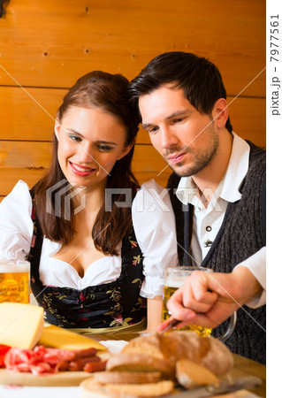 Young couple in a hunters cabin eating Young couple in a hunters cabin eating 7977561