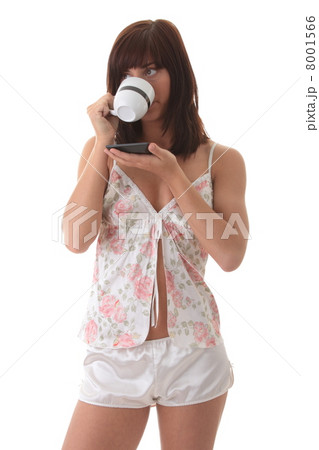 Beautiful young woman is drinking her morning coffee 8001566