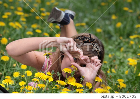 Beautiful woman relaxing in the grass and flowers 8001705