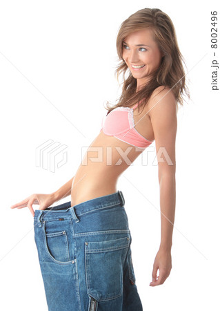 Woman showing how much weight she lost. Woman showing how much weight she lost. 8002496