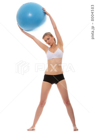 Woman exercising with fitness ball 8004583