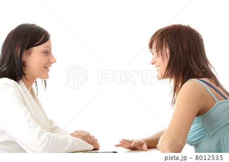 Happy young women friends talking Happy young women friends talking 8012535