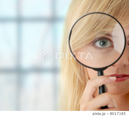 Teen girl with magnifier 8017185