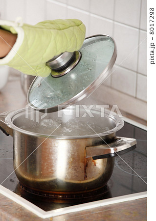 Young woman boiling something in pot 8017298