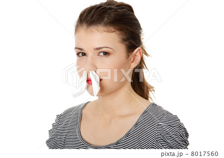 Teen woman with tissue in her nose Teen woman with tissue in her nose 8017560