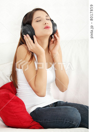 Young beautiful woman at home listening music 8017859