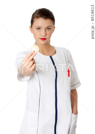 Female doctor holding condom 8018613