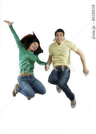 Boy and girl jumping in the air 8026039