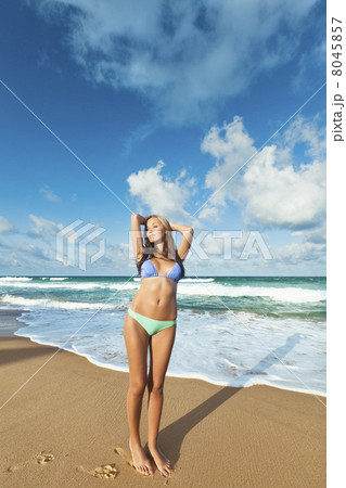 Young woman having a good time on the beach at dawn 8045857
