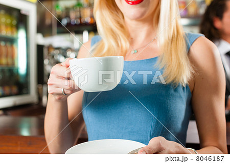 Barista with client in his cafe or coffeeshop Barista with client in his cafe or coffeeshop 8046187