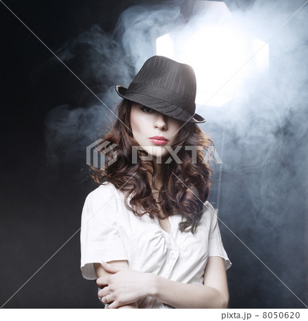 Beautiful brunette girl with black classic hat 8050620