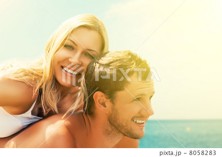 happy couple in love hugging and laughing on the beach happy couple in love hugging and laughing on the beach 8058283