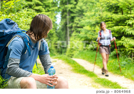 Male hiker looking back waiting the girl 8064968