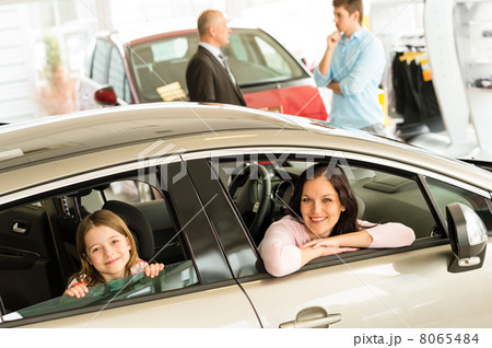 Mother and daughter trying car in dealership 8065484