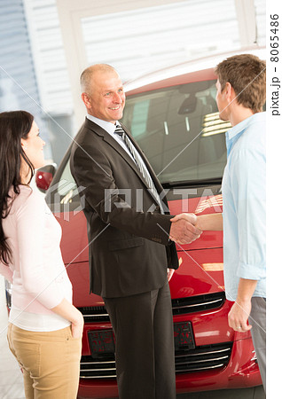 Couple buying a car in dealership 8065486