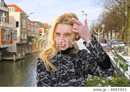Girl on the waterfront in the Dutch town of Gorinchem. Netherlan 8065933