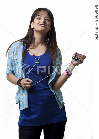 Young woman listening to music on white background 8069998