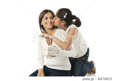 Girl kissing her mother on the cheek Girl kissing her mother on the cheek 8070025