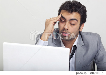 Businessman feeling sleepy at work Businessman feeling sleepy at work 8070063