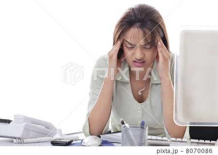 Stressed young businesswoman with head in hands at office Stressed young businesswoman with head in hands at office 8070086