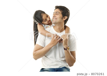 Girl wrapping her arms around her fathers neck Girl wrapping her arms around her fathers neck 8070261