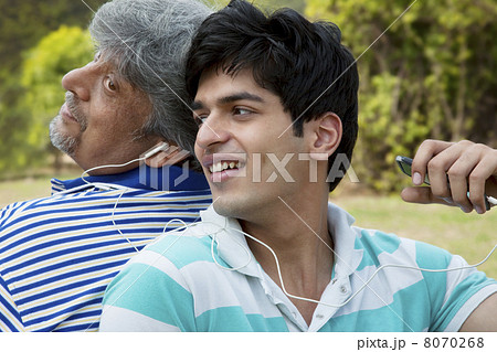 Father and son listening to music Father and son listening to music 8070268