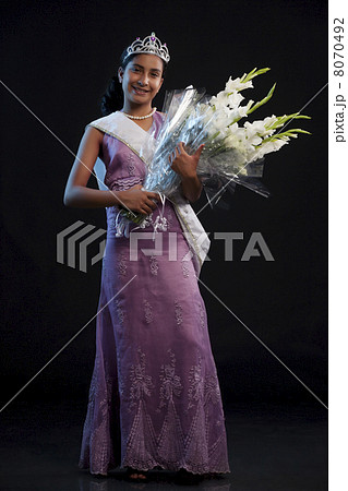Teenage beauty queen holding a bouquet 8070492