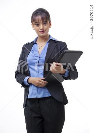 Portrait of beautiful young businesswoman holding laptop over white background 8070514