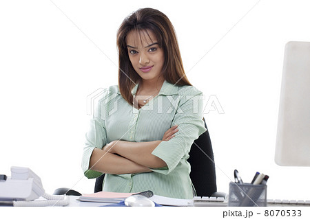 Portrait of attractive young businesswoman with arms crossed at office Portrait of attractive young businesswoman with arms crossed at office 8070533