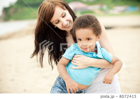 Multi-Ethnic family relaxing together outdoors 8072415