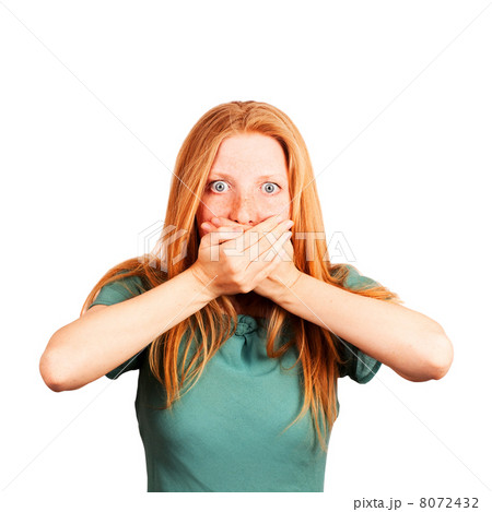 Close-up of a beautiful young woman with hands covering mouth 8072432
