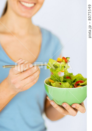 woman eating salad with vegetables woman eating salad with vegetables 8075549