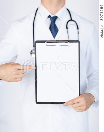 doctor pointing at blank white paper 8075564