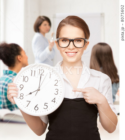 attractive student pointing at clock 8075602